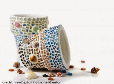 Two small planters with broken glass and shell mosaics