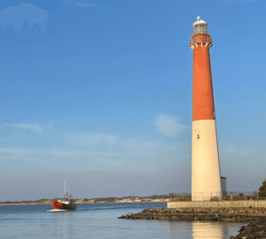 red boat in water by light house