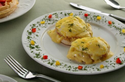 Close up view of Eggs Benedict dish on white plate