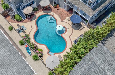 Aerial view of property's pool and patio area
