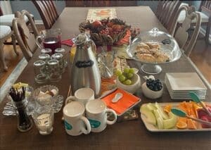 coffee/juice/scones/fruit spread on a table