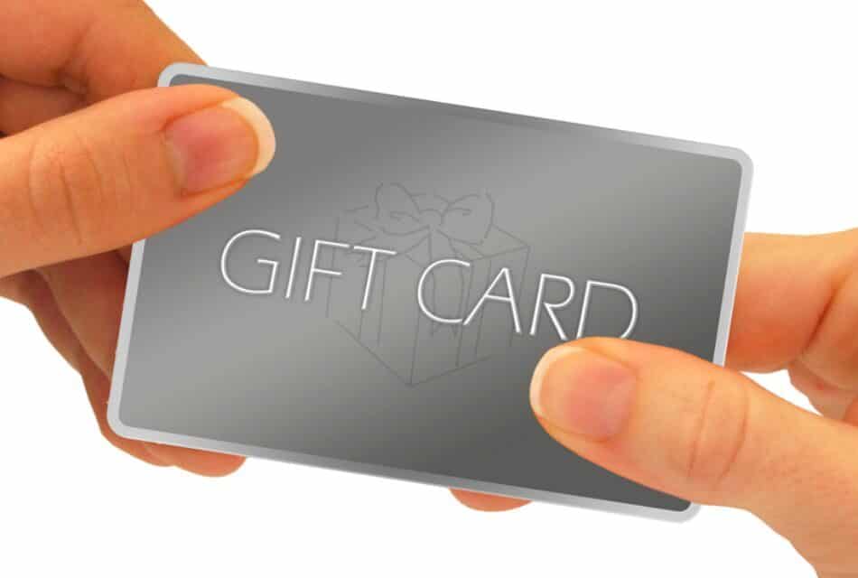 Close up view of a gray gift card held by two hands