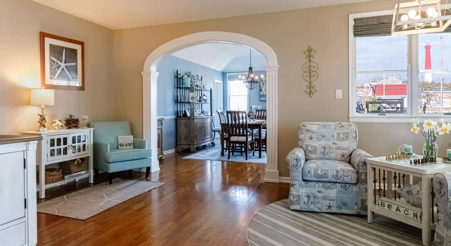 Game room with light tan walls, hardwood flooring, sitting area, and view into dining room